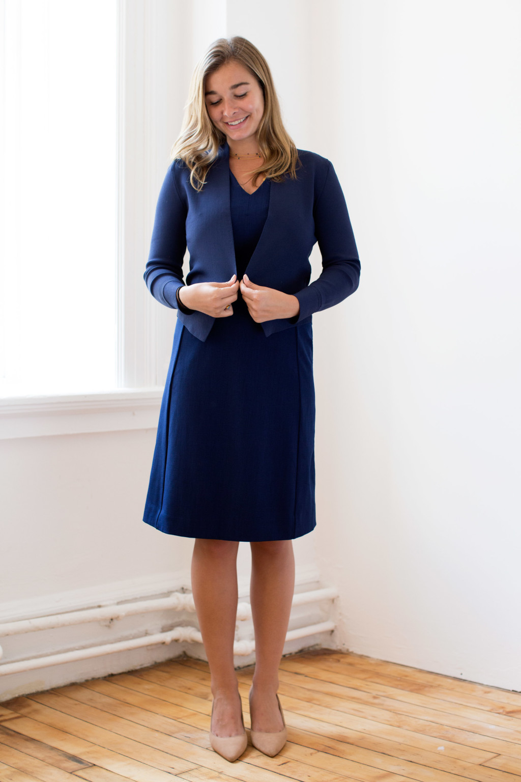Hailey wears the Annie dress and the Sant Ambroeus jardigan, both in deep indigo.