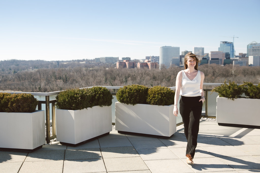 KC Sledd on her office rooftop in the Crawford top in ivory and the Dupont 2.0 pant in black.