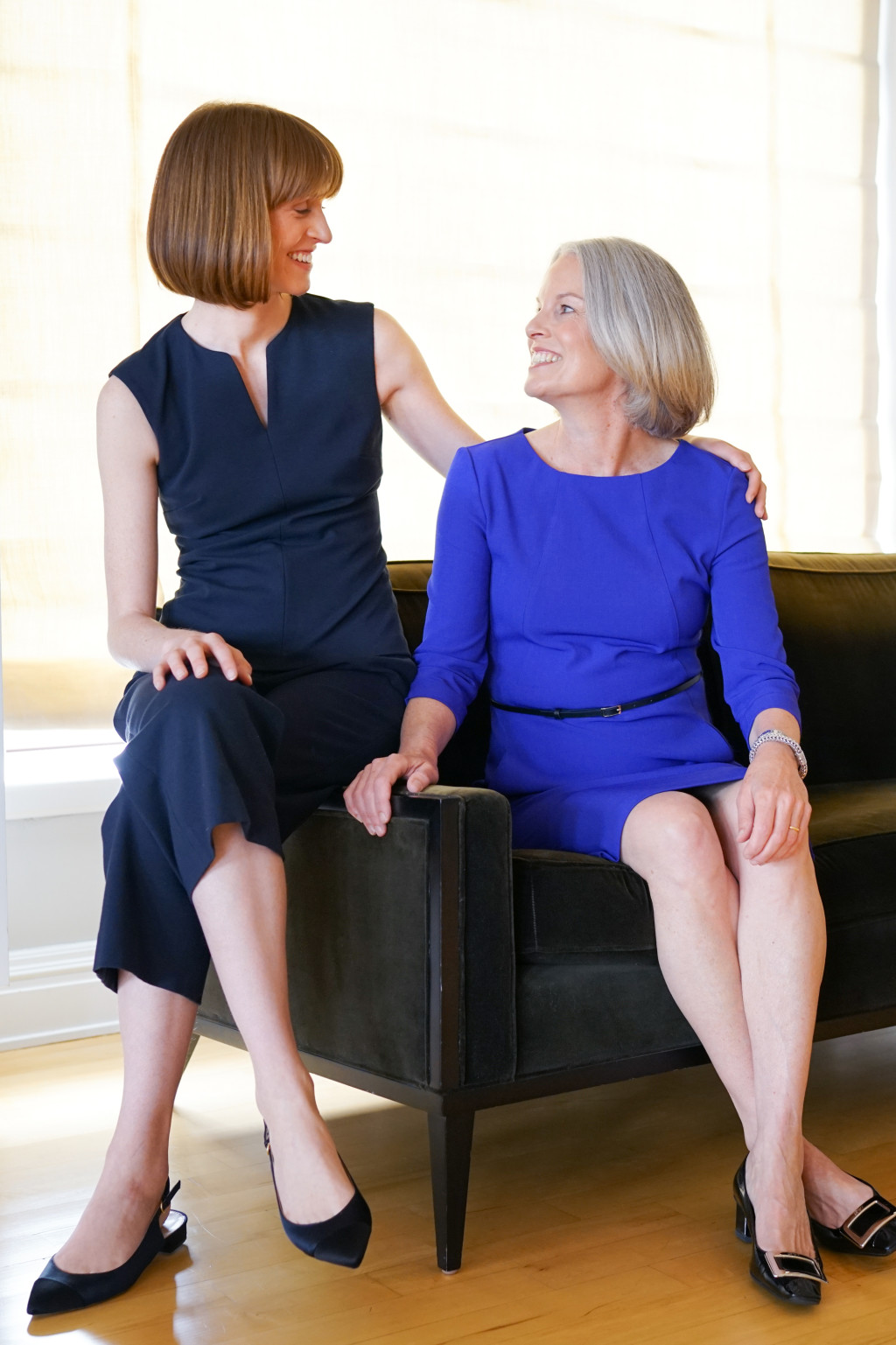 Caroline (left) wears the Colvin top and the Pippa pant in galaxy blue. Susan (right) wears the Etsuko dress in cobalt.